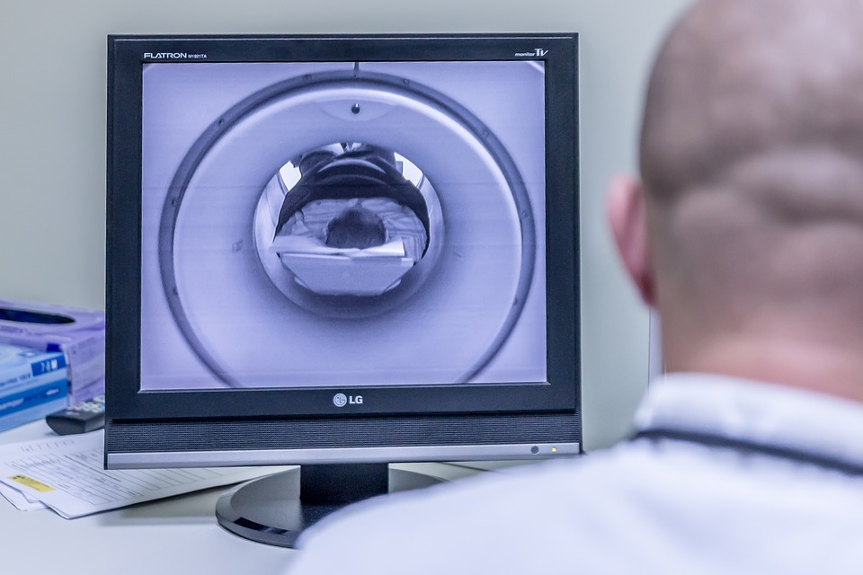 technician watches patient in MRI